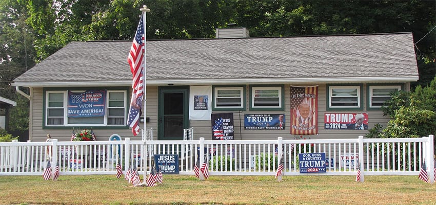 A house with numerous pro-Trump signs, including signs saying "Trump Won" and "Trump 2020."