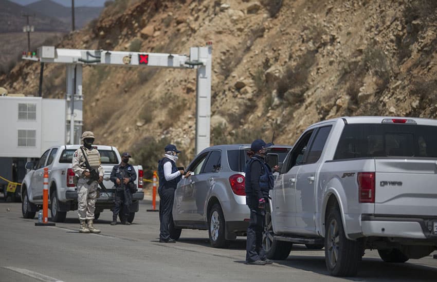 Mexican officials looking for illegal importation of automobiles at the Mexico-U.S. border.