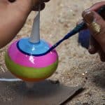 Worker handpaints an ornament at the Castillo de la Esfera ornament factory in Chignahuapan, Puebla, Mexico