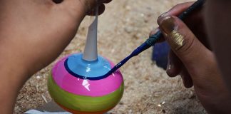 Worker handpaints an ornament at the Castillo de la Esfera ornament factory in Chignahuapan, Puebla, Mexico