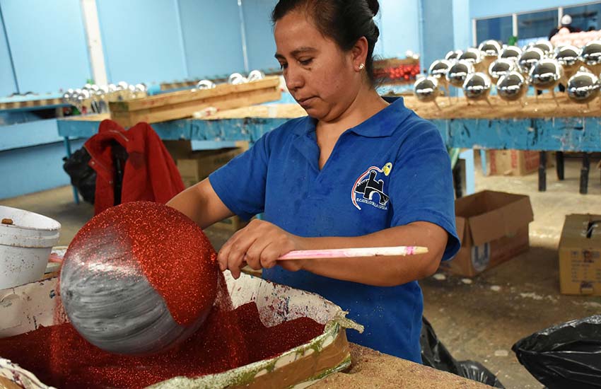 Worker at Christmas ornament factory in Puebla, Mexico