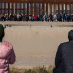 Bundled-up migrants in Ciudad Juárez, Chihuahua, wait to cross into the U.S.