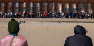 Bundled-up migrants in Ciudad Juárez, Chihuahua, wait to cross into the U.S.