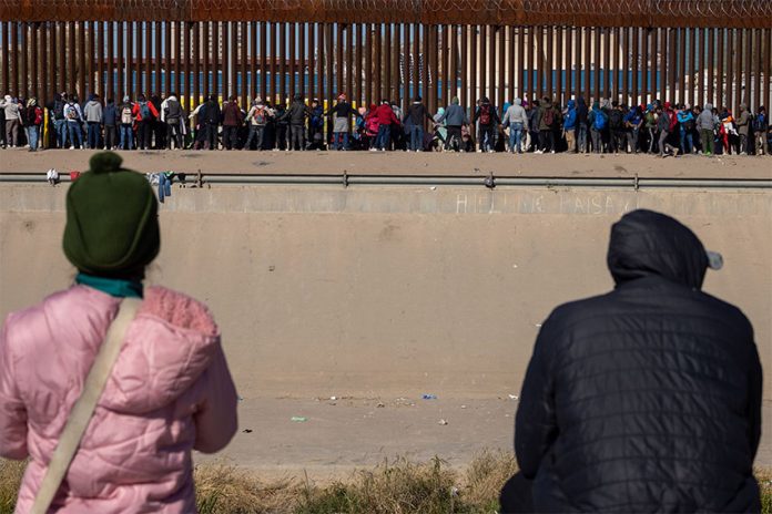 Bundled-up migrants in Ciudad Juárez, Chihuahua, wait to cross into the U.S.