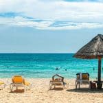 Tourists swim and lounge on a Cancún beach.