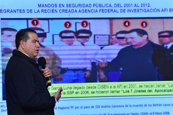 Deputy Security Minister Mejía Berdeja shows a photo of García Luna with several of his alleged collaborators.