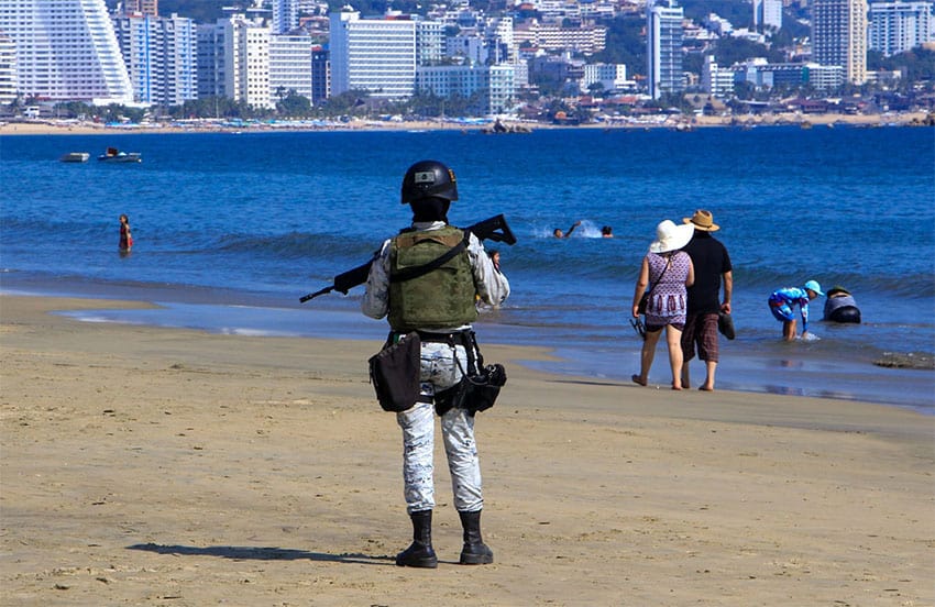 A member of the National Guard patrols a beach in Acapulco, Guerrero.