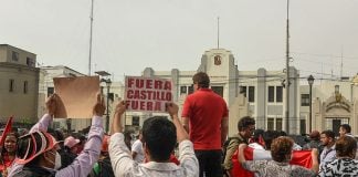 Peruvians gather outside regional headquarters of the Department of Lima to protest on Wednesday after Castillo's attempt to dissolve the national legislature.