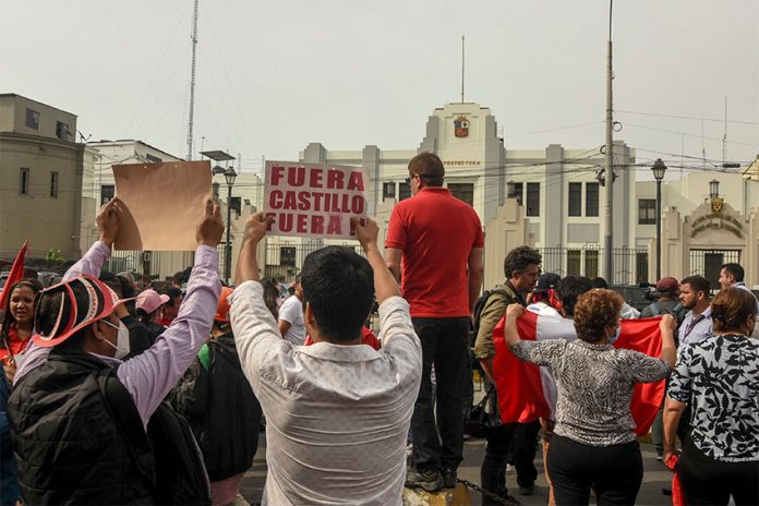 Peruvians gather outside regional headquarters of the Department of Lima to protest on Wednesday after Castillo's attempt to dissolve the national legislature.