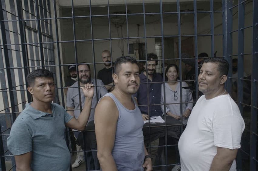 Juan Luis López García, Héctor Muñoz Muñoz, and Gonzalo García Hernández in prison before their release, with director Roberto Hernández and other members of the documentary team in the background.