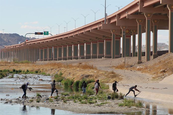 A group of migrants crosses the Rio Grande from Ciudad Juárez to enter the U.S. in March.