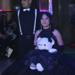 Mexican quinceañera posing with her traditional "last toy"