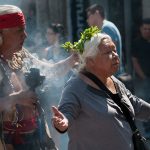 Curandero working with a patient in Mexico City's Zocalo.