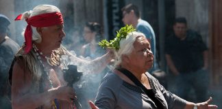 Curandero working with a patient in Mexico City's Zocalo.