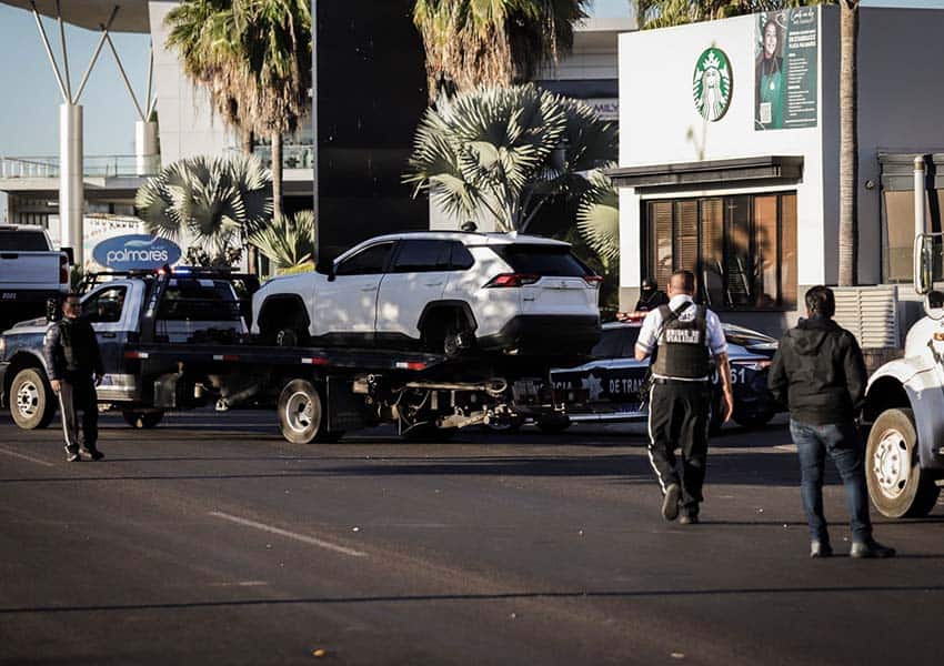 People dealing with destroyed vehicles in Culiacan, Sinaloa after arrest of cartel leader Ovidio Guzman led to fires and shooting