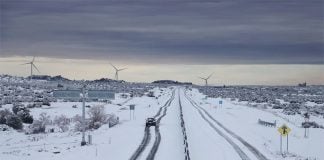A lone car navigates a snowy highway near La Rumorosa, Baja California.