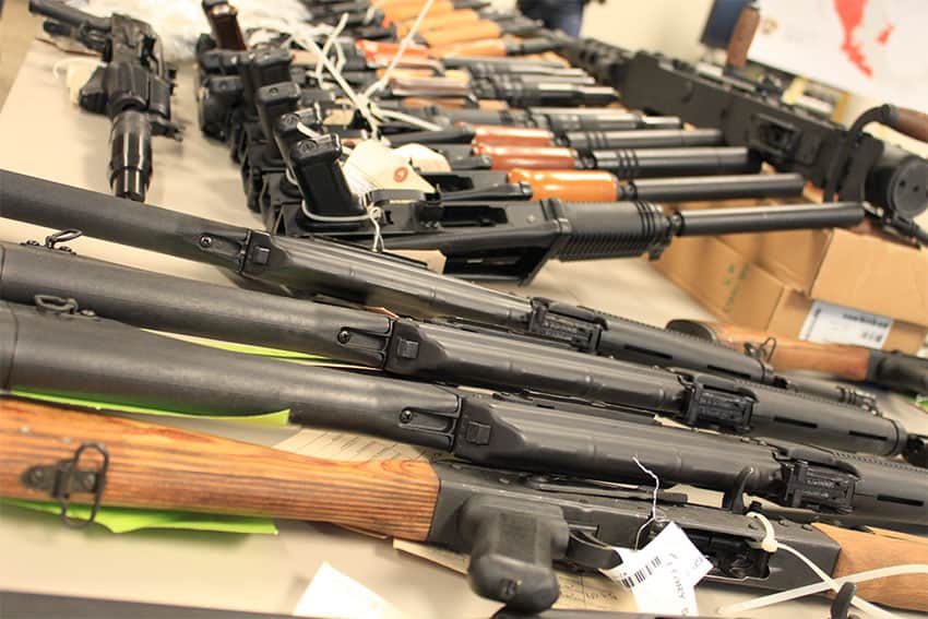 Handguns, AK-47s, .50 caliber rifles and other weapons displayed at a press conference on arrests and weapon seizures by Operation Fast and Furious.