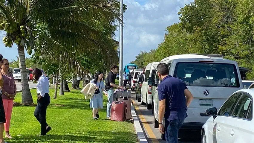 Tourists leave their rides on Monday in an effort to make it to the airport on foot.
