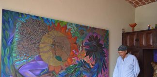 Mexican artist Antonio López Vega with painting at the La Cochera Cultural Center of Ajijic