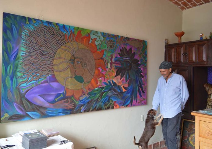 Mexican artist Antonio López Vega with painting at the La Cochera Cultural Center of Ajijic