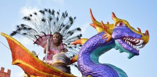 Woman on alebrije float at the Carnival of Santa Marta Acatitlán