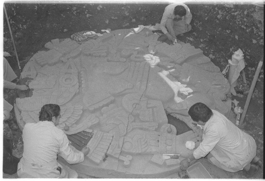 Archaeologists work on the stone of Coyolxauhqui