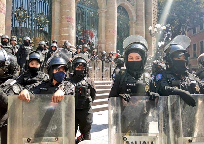 police guarding Mexico City Chamber of Deputies building after transgender rights protest