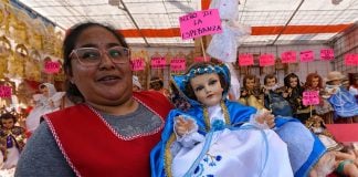 A vendor at the Juárez market in México state displays one of her baby Jesus figurines.