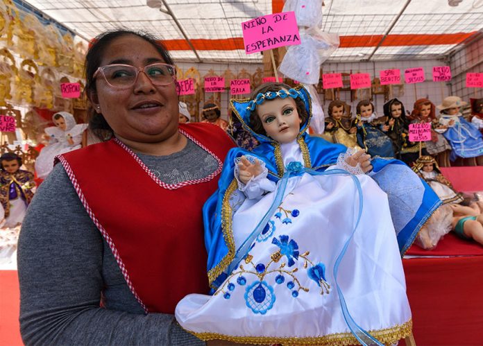 A vendor at the Juárez market in México state displays one of her baby Jesus figurines.