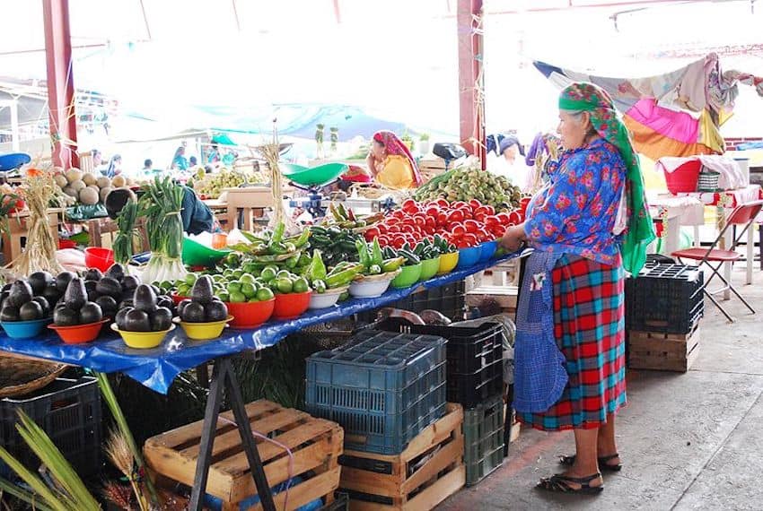 A stallholder sells vegetables at a tianguis