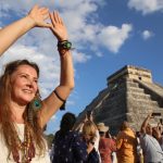 A tourist celebrates the equinox at the temple of Kulkulcan