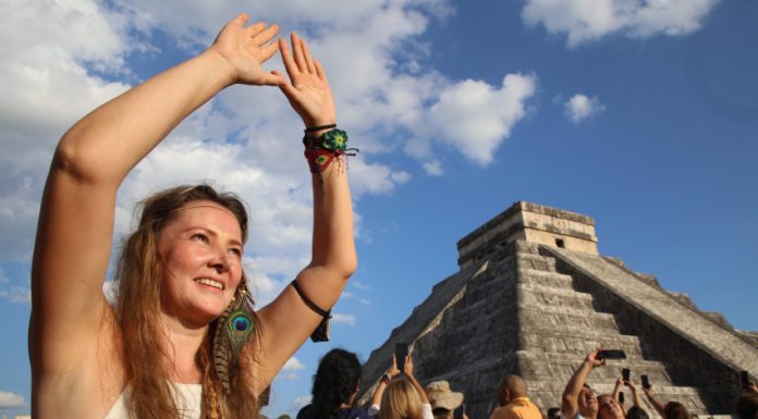 A tourist celebrates the equinox at the temple of Kulkulcan