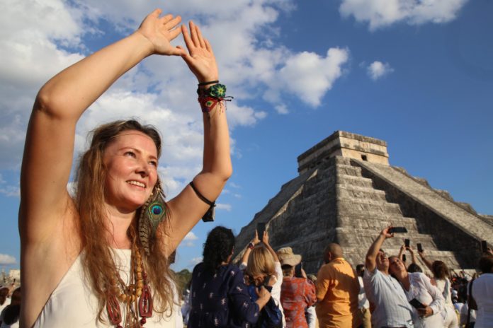 A tourist celebrates the equinox at the temple of Kulkulcan