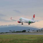 An airbus A320 takes off into the evening