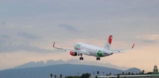 An airbus A320 takes off into the evening