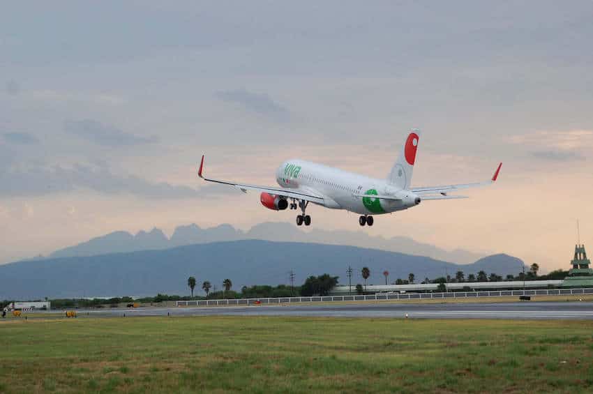 An airbus A320 takes off into the evening