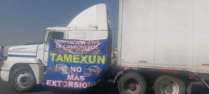 A truck blocks a highway in protest of police extortion