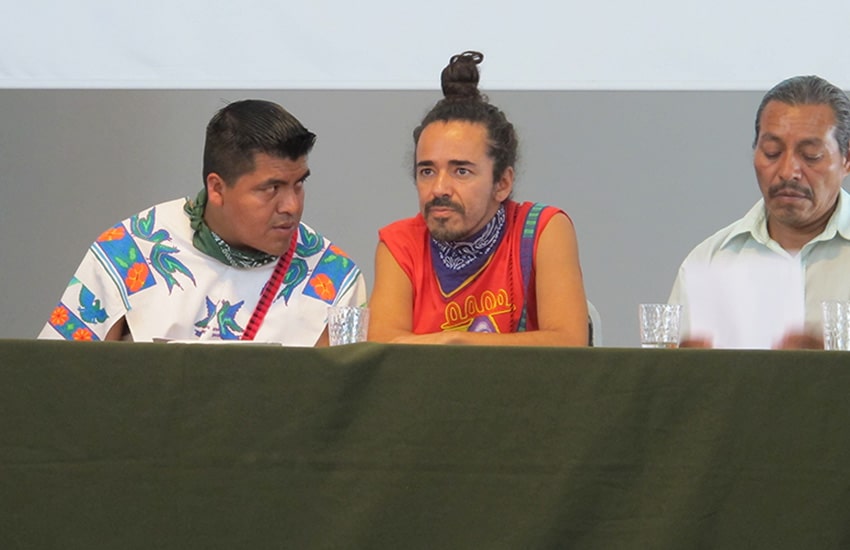 Santos de la Cruz, left, consults with Ruben Albarran, center, of Cafe Tacvba band