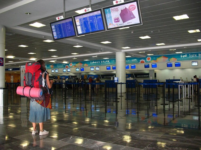 A traveler stands in the Cancun airport.