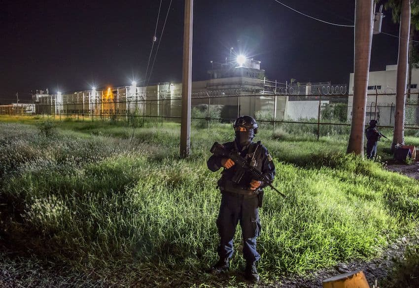 The Aguaruto prison in Sinaloa, at night time, surrounded by armed guards