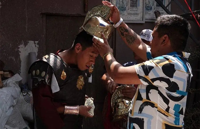 Youth getting ready for a Holy Week procession dressed as Roman soldier