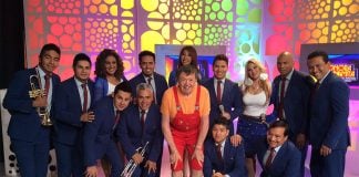 Mexican performer Xavier Lopez Chabelo posing on his variety show En Familia Con Chabelo with Mexican band Sonora Dinamita de Lucho Argain