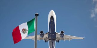 Plane flying over Mexican flag