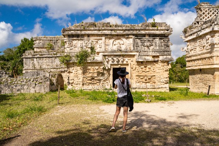Woman looking at Chichén Itzá ruins in Yucatán