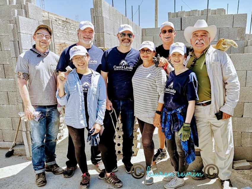 Volunteers help build a house