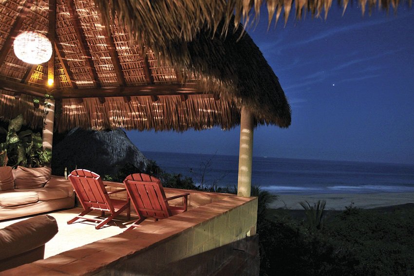 A terrace in Mazunte, Oaxaca, overlooks the ocean at night.