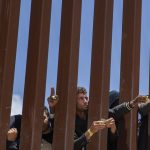Migrants at the US-Mexico border in Tijuana on May 11.