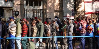 Haitian migrants wait in a queue