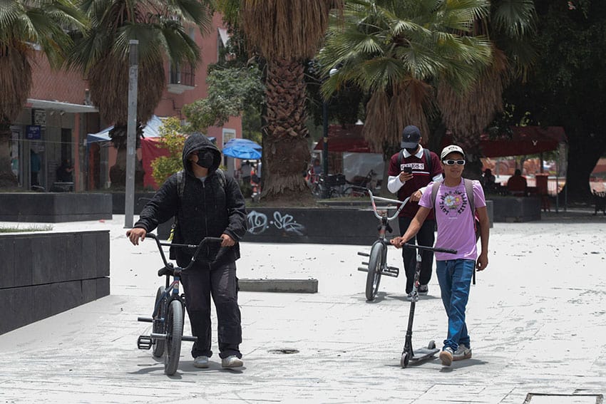 Residents of Puebla city walking among ash eruptions on the ground from El Popocatepetl volcano