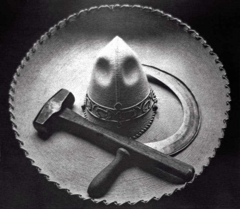 Mexican sombrero with a hammer and sickle crossed on its brim.